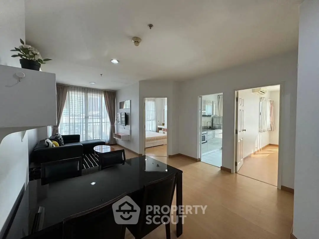 Spacious open-plan living room with dining area and natural light