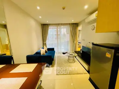 Modern living room with sleek design and cozy atmosphere, featuring a stylish blue sofa and elegant decor.