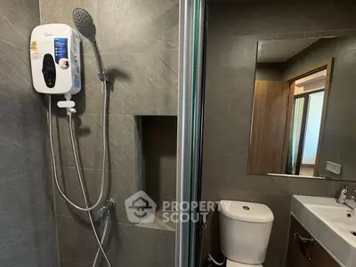 Modern bathroom with sleek shower and contemporary fixtures.