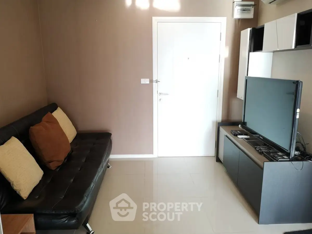 Modern living room with sleek furniture and large TV setup