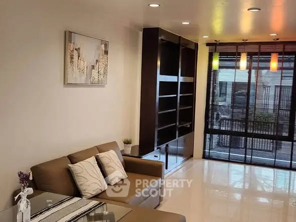 Modern living room with stylish decor and large windows for natural light.