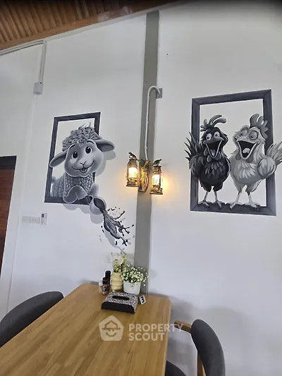 Charming dining area with unique animal wall art and cozy wooden table setting.