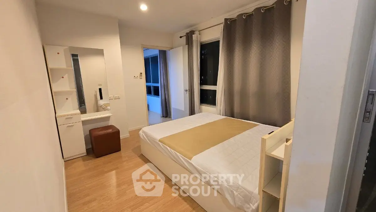 Modern bedroom with cozy decor and natural light in a stylish apartment.
