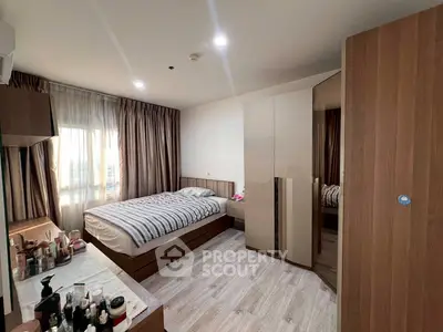 Cozy bedroom with modern decor and ample natural light