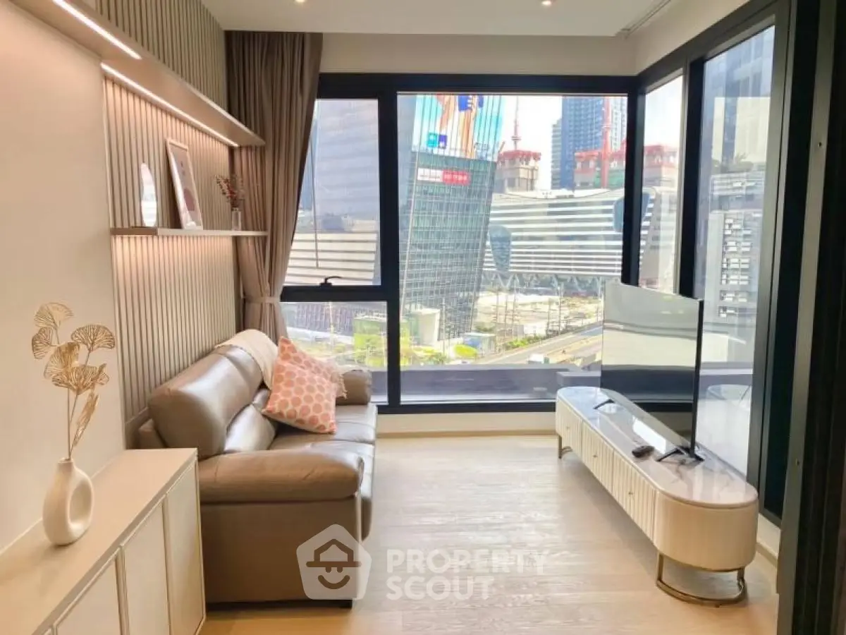 Modern living room with city view, stylish decor, and natural light in urban apartment.
