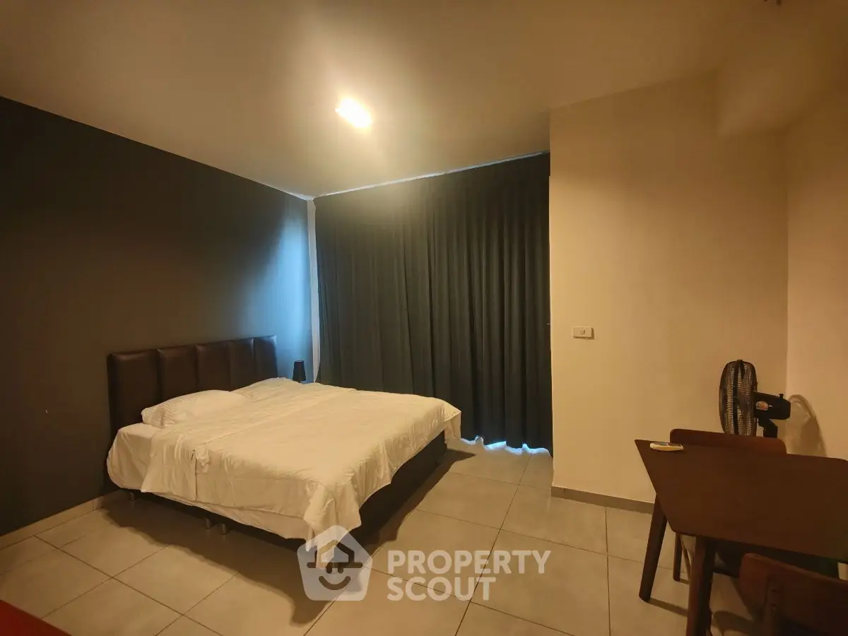 Cozy bedroom with modern decor and natural light, perfect for relaxation and comfort.