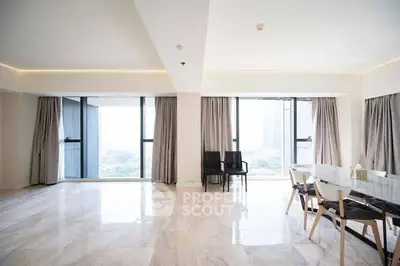 Spacious modern living room with large windows and elegant dining area