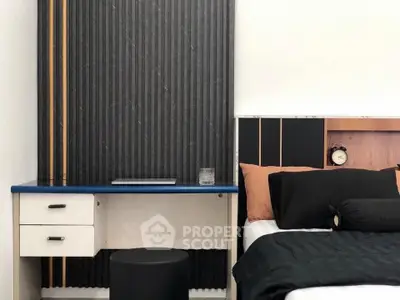 Modern bedroom with stylish desk and cozy bedding