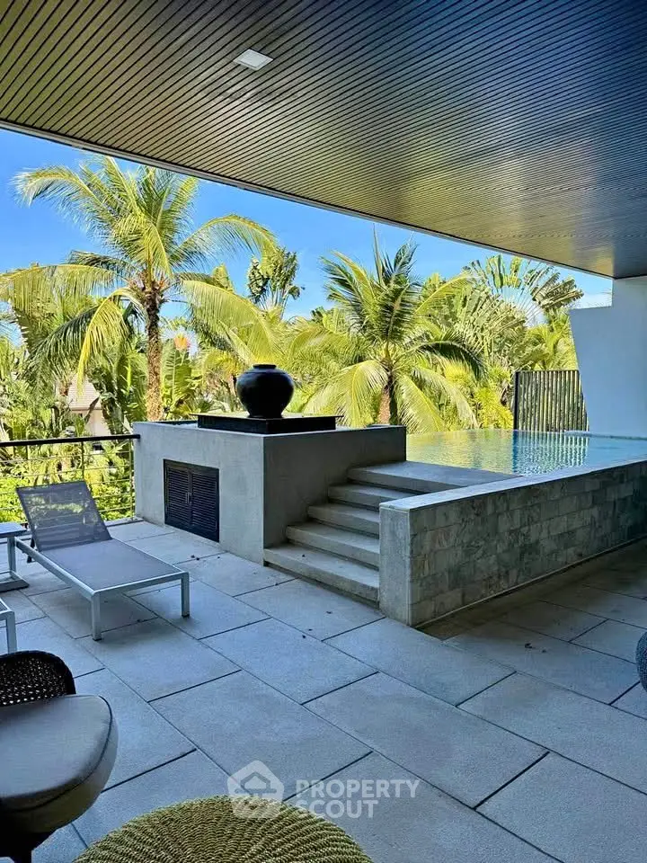 Luxurious balcony with infinity pool and tropical garden view, perfect for relaxation and entertainment.