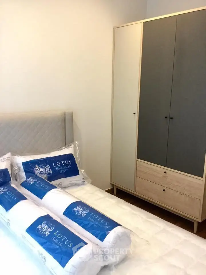 Modern bedroom with stylish wardrobe and comfortable bedding