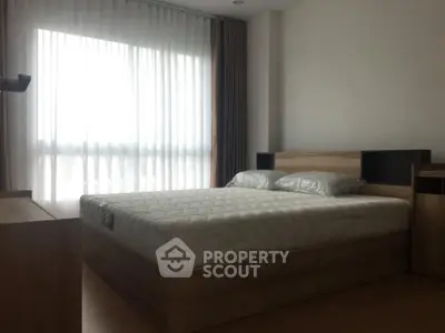Spacious bedroom with modern design and large window for natural light