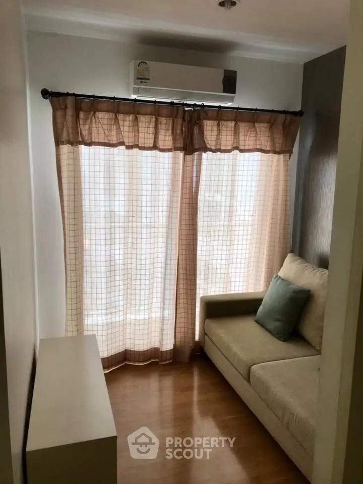 Cozy small living room with natural light and air conditioning