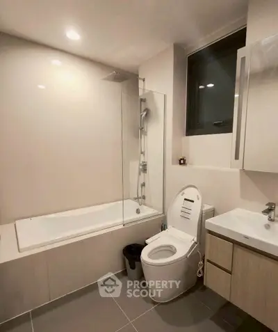 Modern bathroom with sleek fixtures and a bathtub in a contemporary apartment.