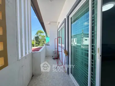 Spacious balcony with sliding glass doors and scenic view, perfect for relaxation and outdoor enjoyment.