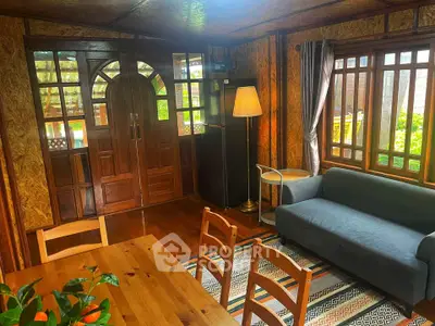 Charming rustic living room with wooden decor and cozy seating area.