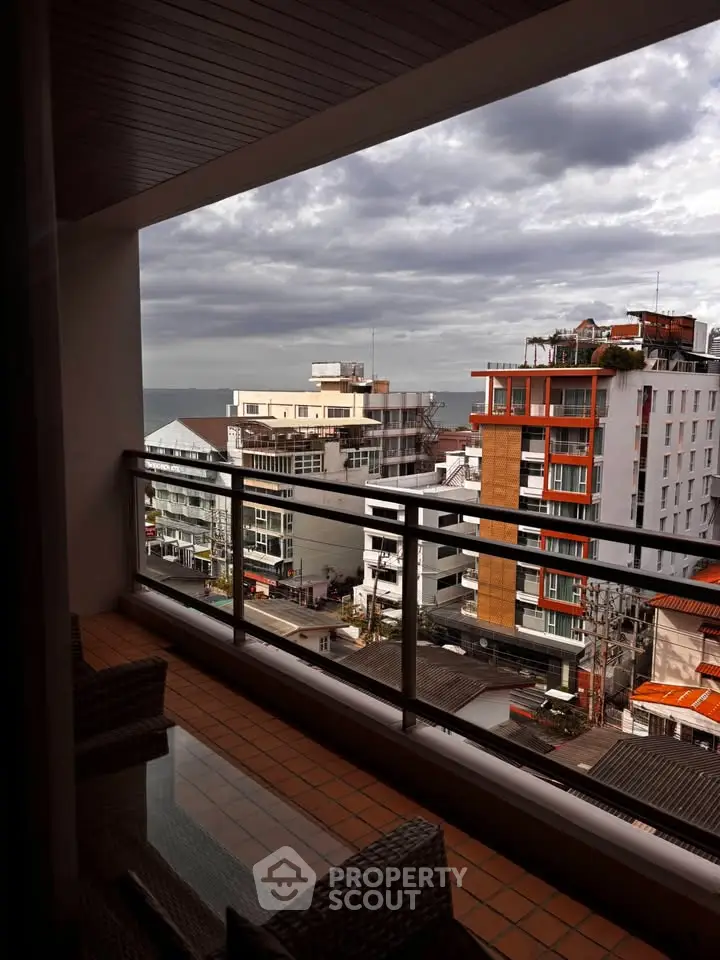 Stunning cityscape view from a modern balcony with ocean in the distance, perfect for urban living.