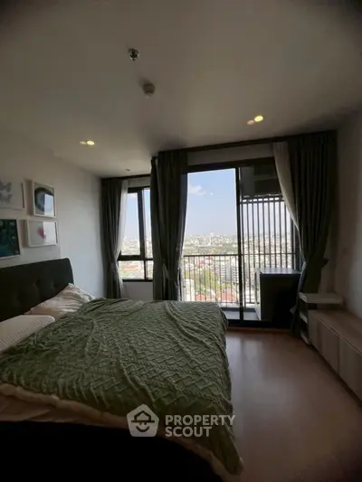 Modern bedroom with city view and large windows in high-rise apartment