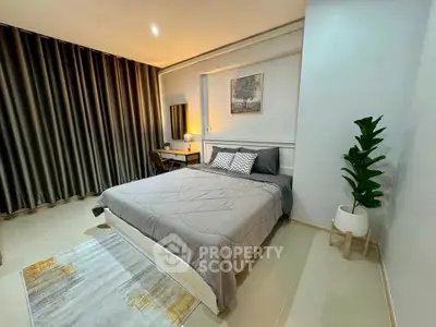 Modern bedroom with stylish decor and cozy ambiance, featuring a comfortable bed and elegant furnishings.