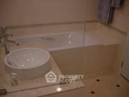 Elegant bathroom with modern fixtures and a luxurious bathtub in a stylish real estate property.