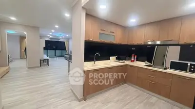 Spacious modern kitchen with open layout and sleek wooden cabinetry