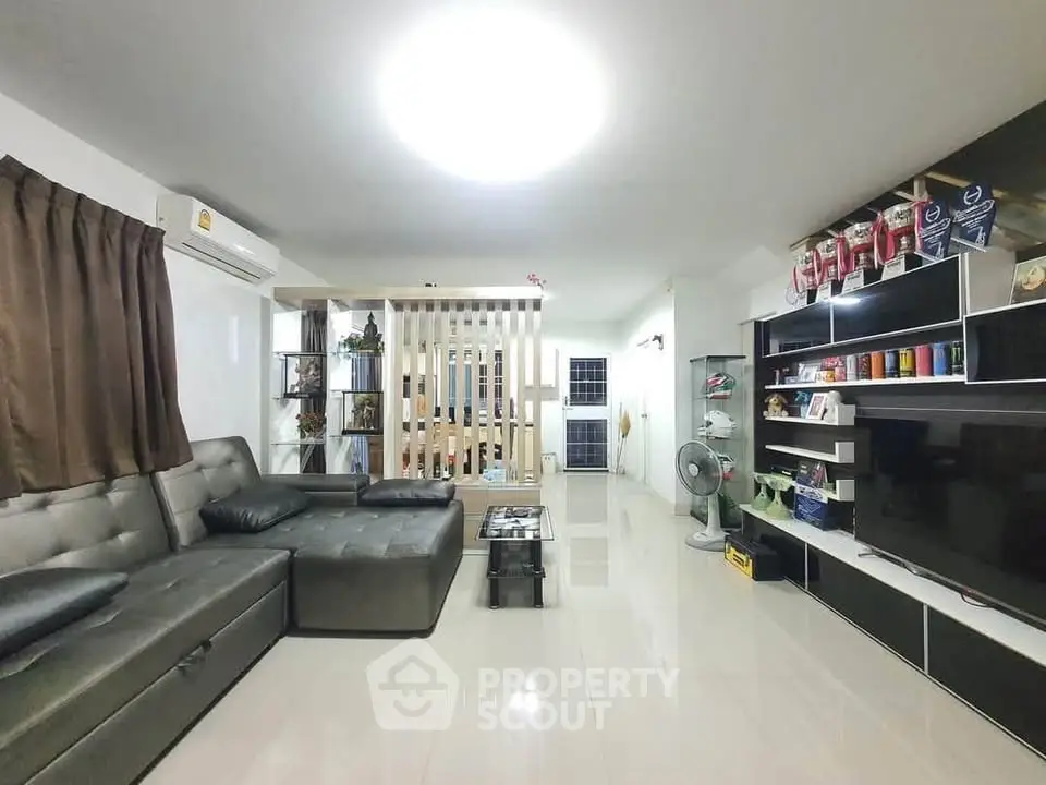 Spacious modern living room with sleek furniture and ample natural light.