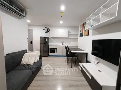 Modern living room with sleek furniture and open kitchen layout