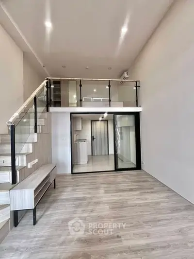 Modern loft-style living room with mezzanine and sleek wooden flooring