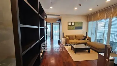 Spacious living room with modern decor and large windows for natural light.