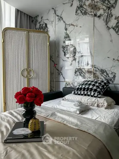 Luxurious bedroom with marble accent wall and elegant decor