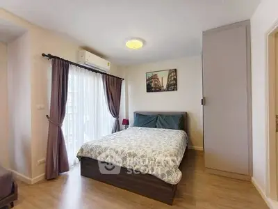 Cozy bedroom with natural light, modern decor, and ample storage in a stylish apartment.