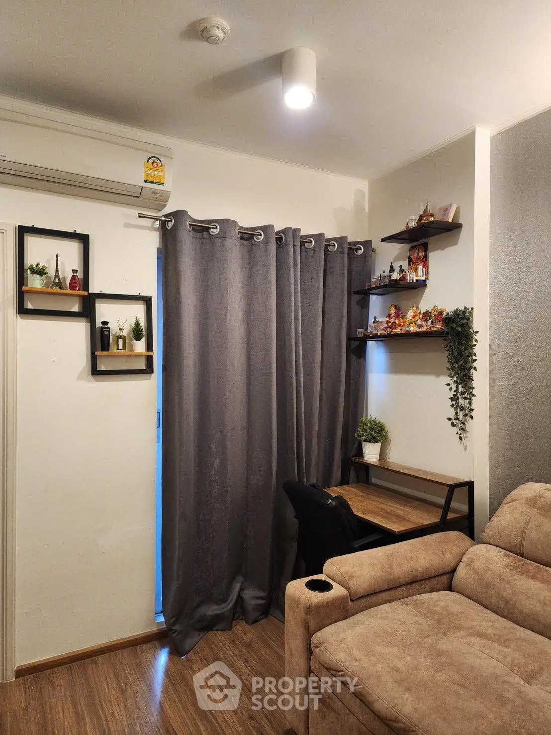 Cozy living room with modern decor and comfortable seating, perfect for relaxation and productivity.
