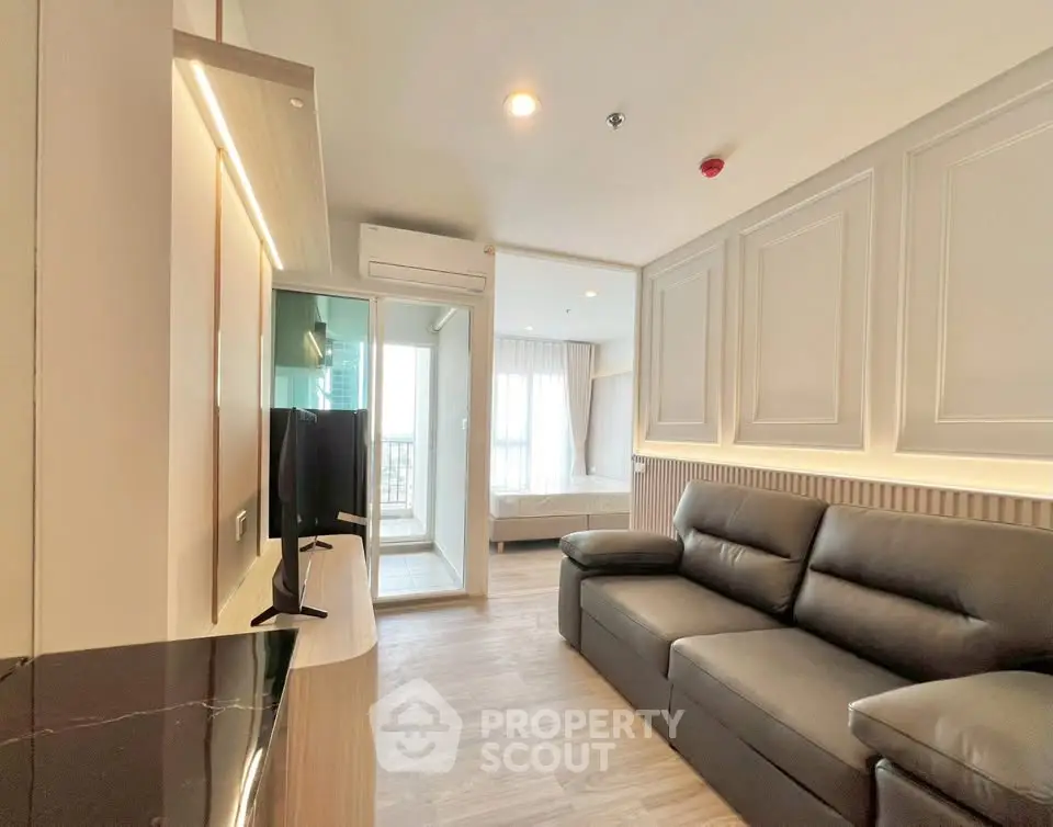 Modern living room with sleek design and natural light, featuring a comfortable sofa and stylish decor.