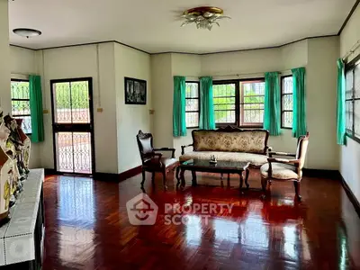 Charming living room with vintage furniture and polished wooden floors.