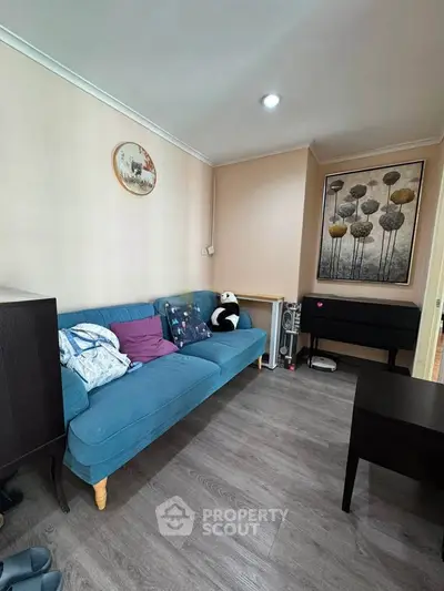 Cozy living room with stylish blue sofa and modern decor
