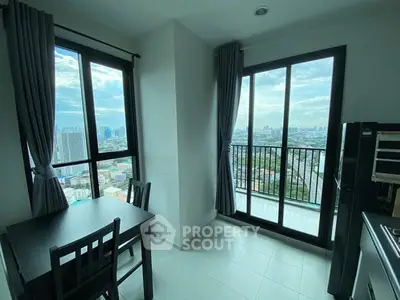 Bright dining area with city view and large windows in modern apartment