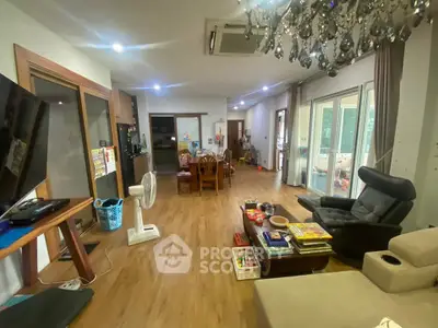 Spacious living room with modern decor and large windows for natural light.