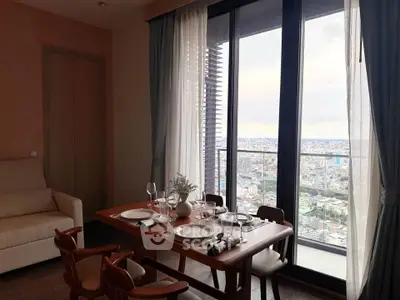 Elegant dining area with city view from high-rise balcony, featuring modern furniture and stylish decor.