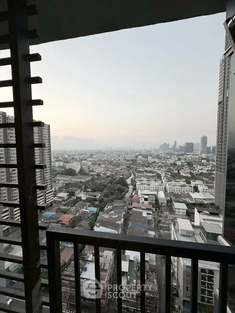 Stunning cityscape view from high-rise balcony showcasing urban skyline and vibrant city life.