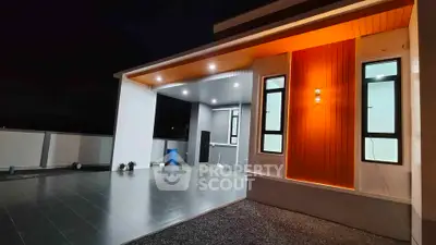 Modern house exterior with stylish lighting and spacious patio at night