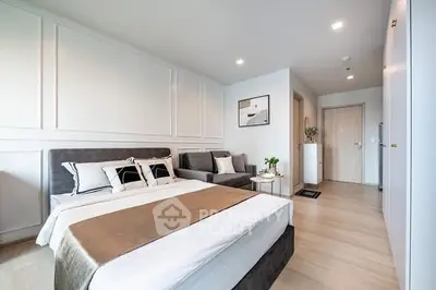 Modern bedroom with stylish decor and cozy seating area in a contemporary apartment.