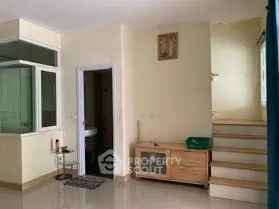 Cozy interior with staircase and bathroom, featuring modern decor and natural light.