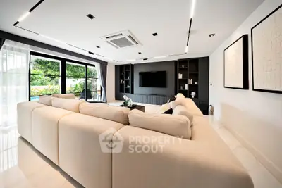 Luxurious modern living room with large sectional sofa and garden view.
