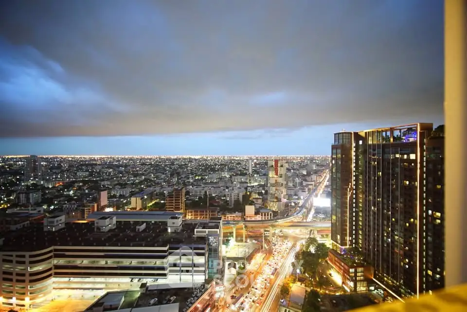 Stunning cityscape view from high-rise building at dusk, showcasing vibrant urban life and modern architecture.