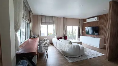 Spacious modern living room with elegant decor and large windows