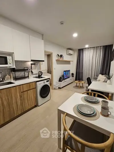 Modern open-plan kitchen and living area with stylish decor and appliances