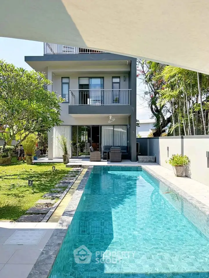 Luxurious modern home with private pool and lush garden, perfect for relaxation and entertaining.