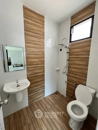 Modern bathroom with wood-style tiles and sleek fixtures