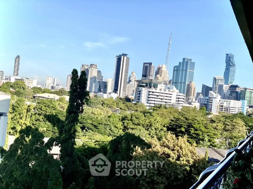 Stunning city skyline view with lush greenery, perfect for urban living enthusiasts.