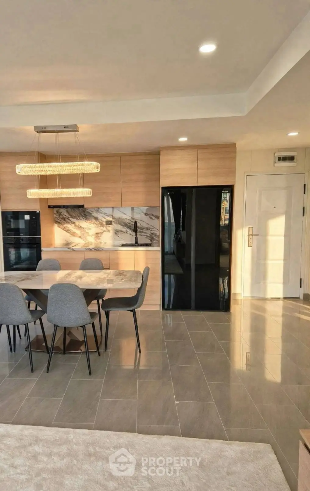 Modern kitchen with sleek design, featuring open layout and elegant dining area, perfect for contemporary living.