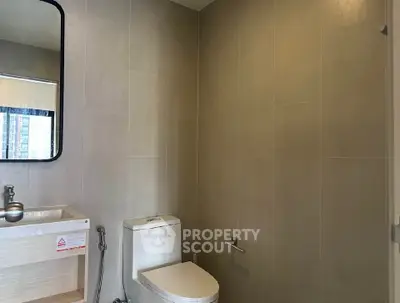 Modern bathroom with sleek fixtures and neutral tiles, perfect for a contemporary home.